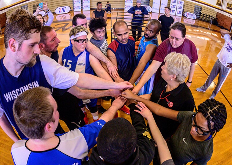 Special Olympics basketball players huddle up during practice the day before the Unified basketball game during NBA All-Star weekend. 