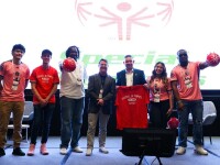 A group of people standing on a stage. 