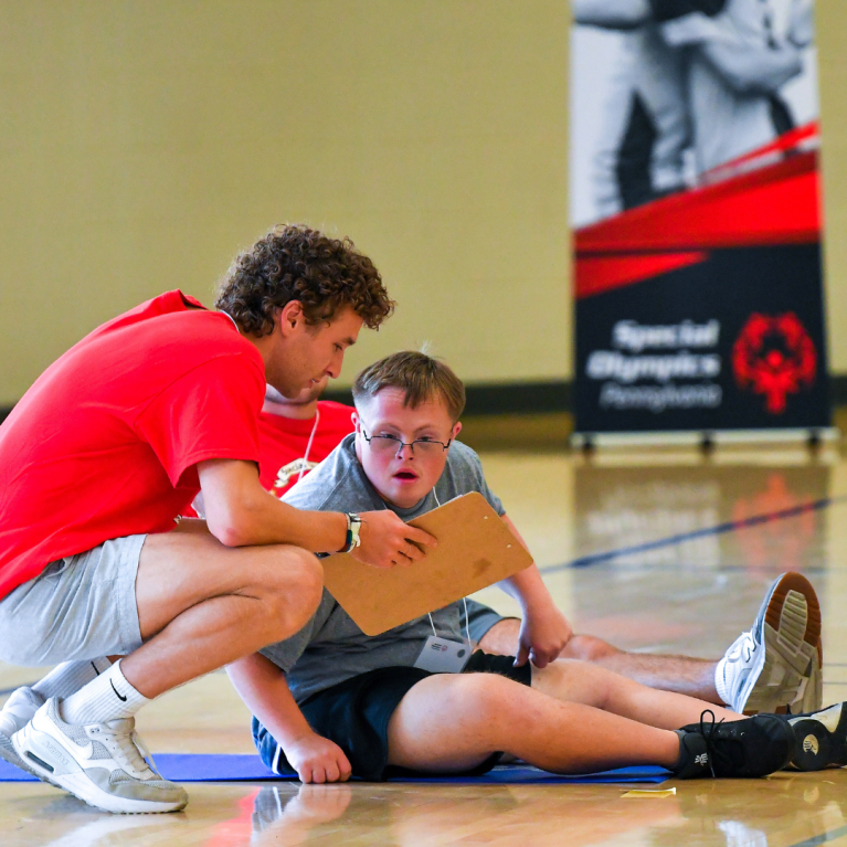 Athlete receiving workout feedback from a fitness professional. 