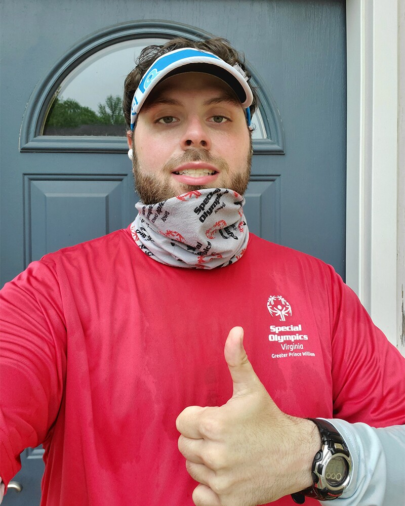 Jerry Holy giving a thumbs up in front of his front door after a run.