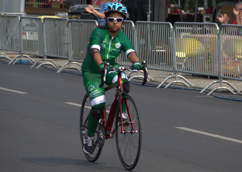 Athlete cyclist pedals towards finish line.