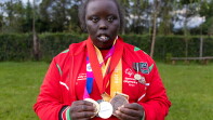 Athlete shows off medals.