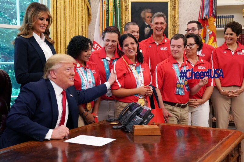 The President congratulates Delina Rodrigues, Special Olympics USA powerlifter from Pennsylvania, and her fellow Special Olympics USA athletes during a meeting with members of the USA delegation that competed at the Special Olympics World Games Abu Dhabi 2019 in the Oval Office of the White House in Washington, D.C., U.S., on Thursday, July 18, 2019.