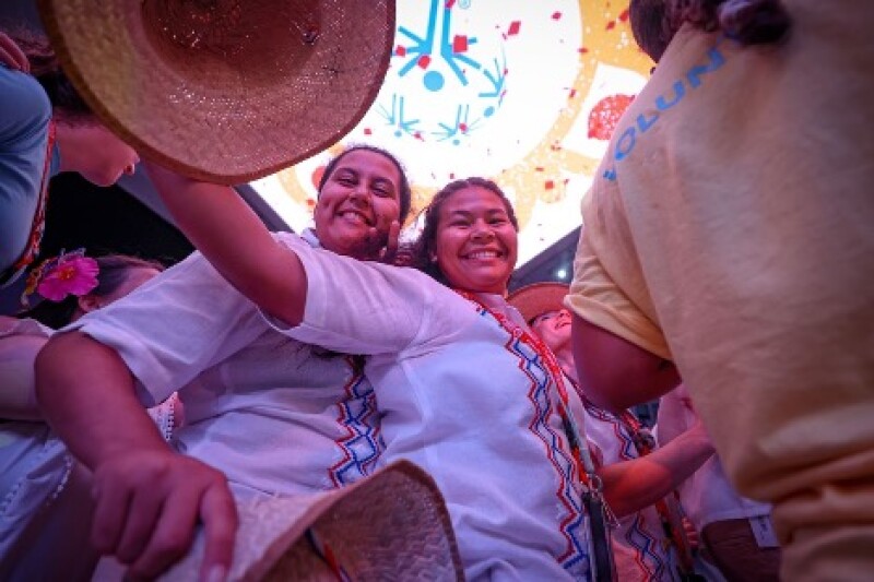 Two women smile at the camera during the party