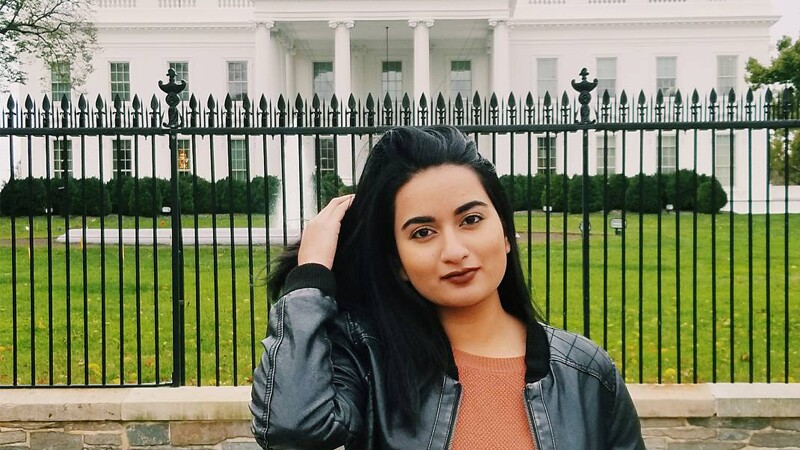 Aaisha Sanaullah, Special Olympics Legal Intern, standing in front of the white house.