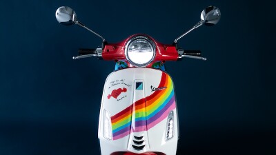 red vespa cycle front with rainbow design