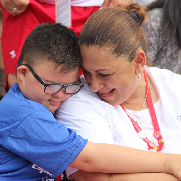Mother and son embracing with a hug. 