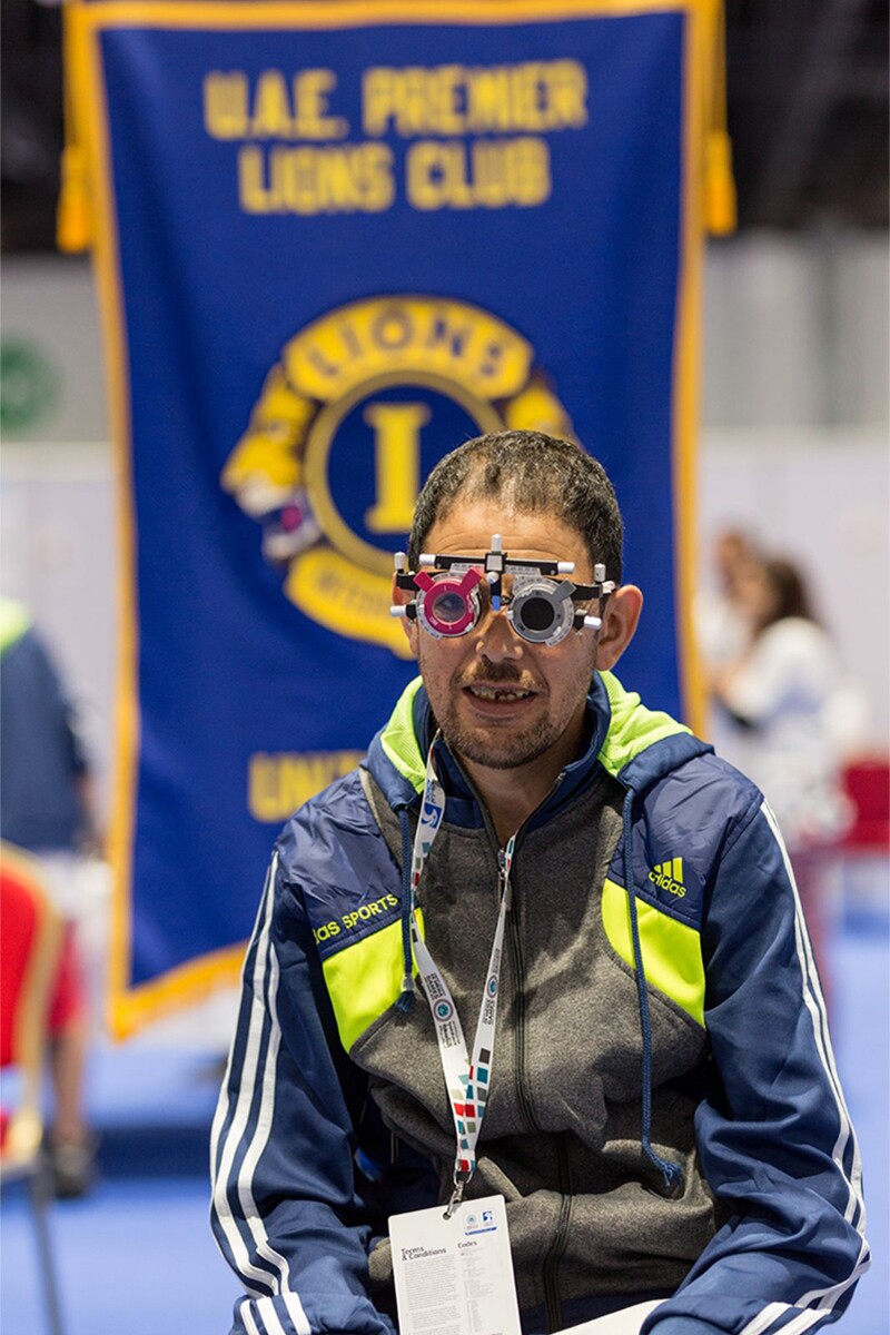 Athletes sitting with an ocular testing device over his face.