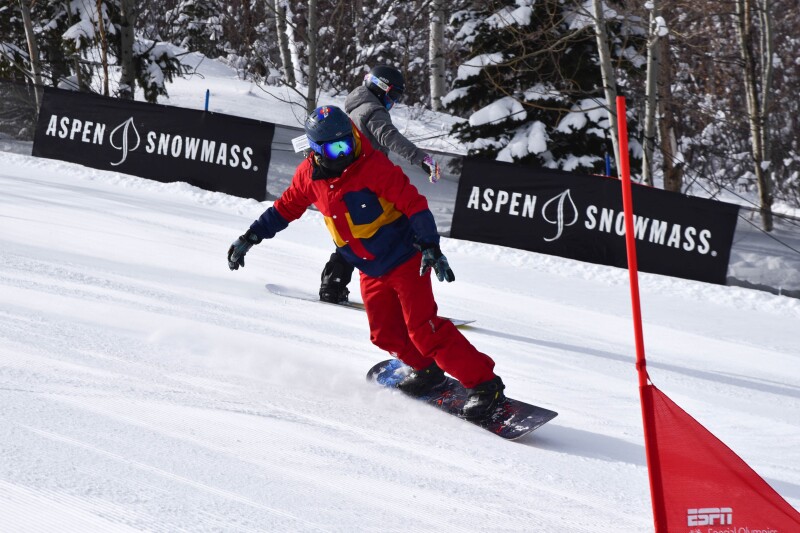 Gold medalist Henry Meece on a practice run down the slope on a snowboard.