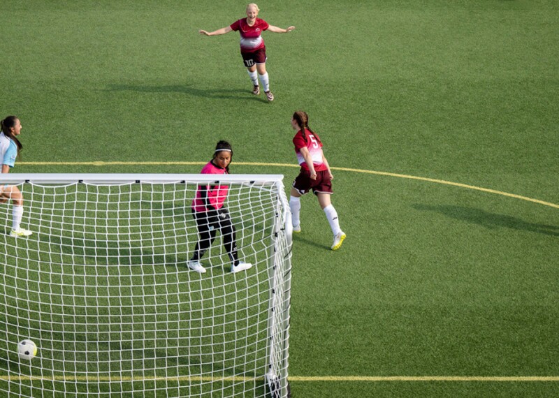female footballers on the pitch playing. 