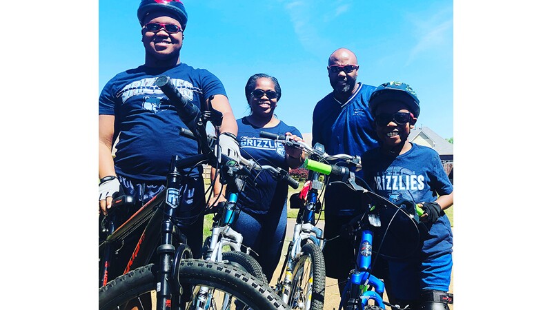 Eric and his family enjoy a bike ride together.