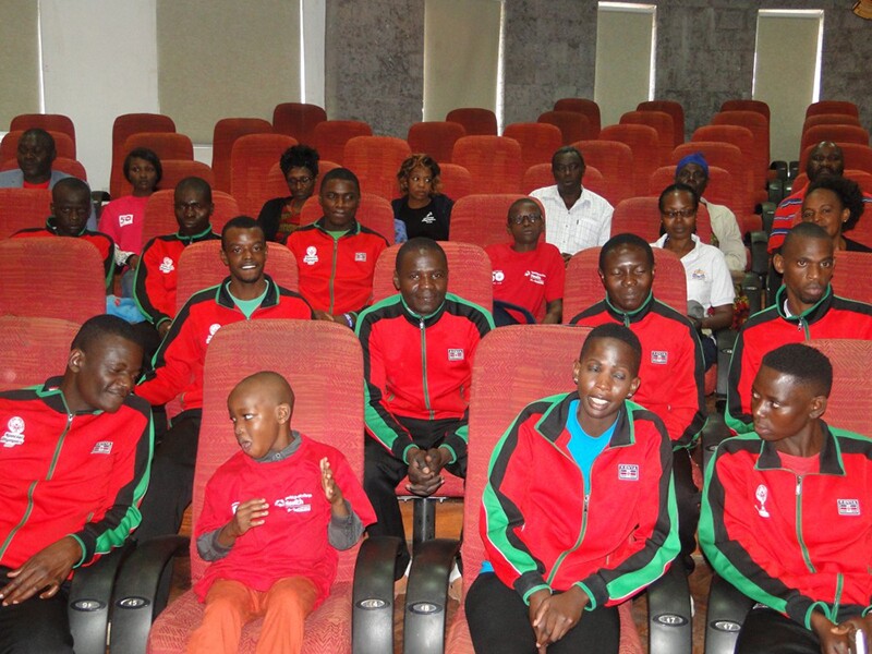 Group of athletes from Kenya sitting in theater seating.