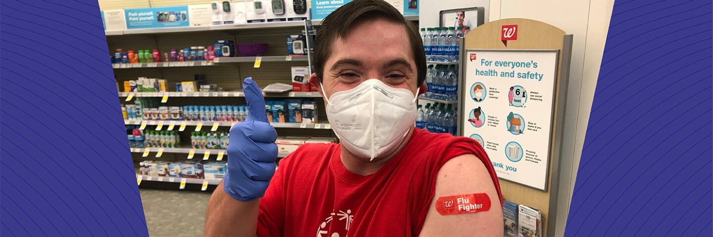 Athlete after receiving a flu shot and giving a thumbs up.