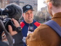 Man talking to reporters. 