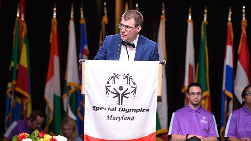 RJ Nealon speaks at podium.