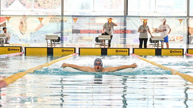 A young man doing the butterfly stroke.