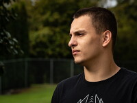 Tanner standing in a field looking off into the distance. 