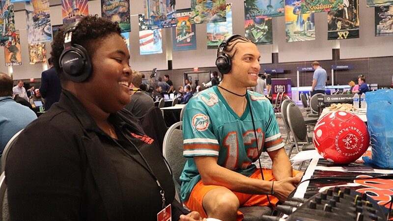 Tajha interviewing Mack Hollins at a table.