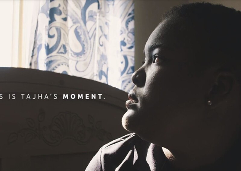 Tajha stairing off out the window. Text on the image reads: This is Tajha's moment. 