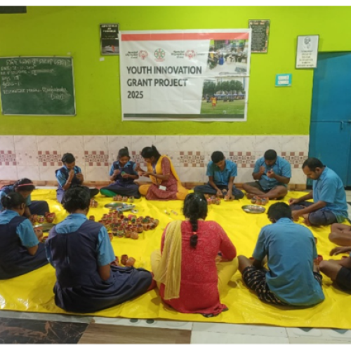 Young people sitting on the floor in a circle. 