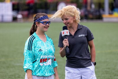 Daina interviewing fellow athlete on the field. 