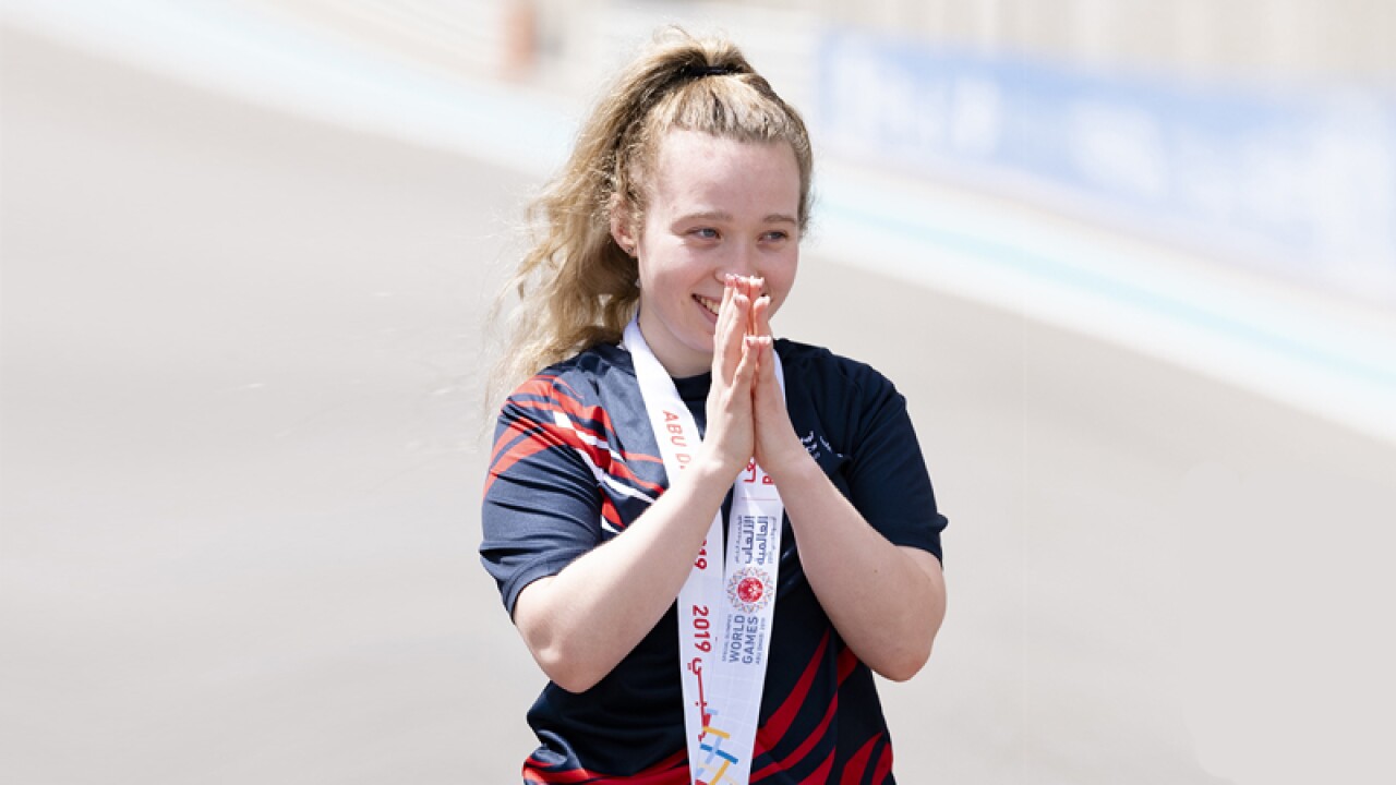 Kiera Byland standing with a gold medal around her neck.