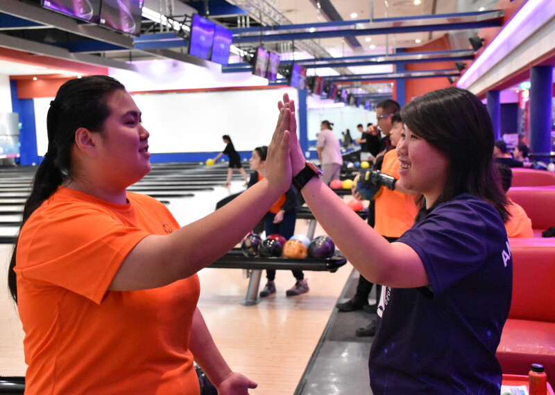 Two athletes celebrating at bowling. 