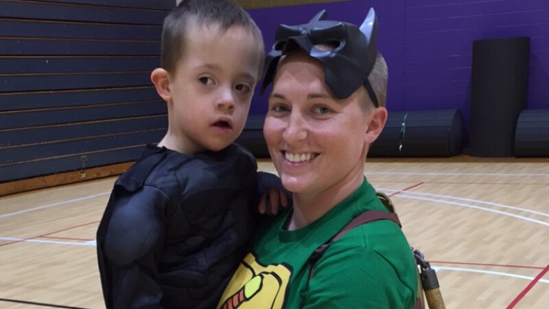 Monica Klock holding young child