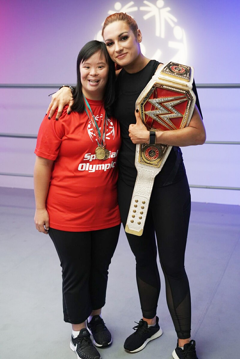Stephanie Ching and Becky Lunch from WWE standing side by side in the ring.