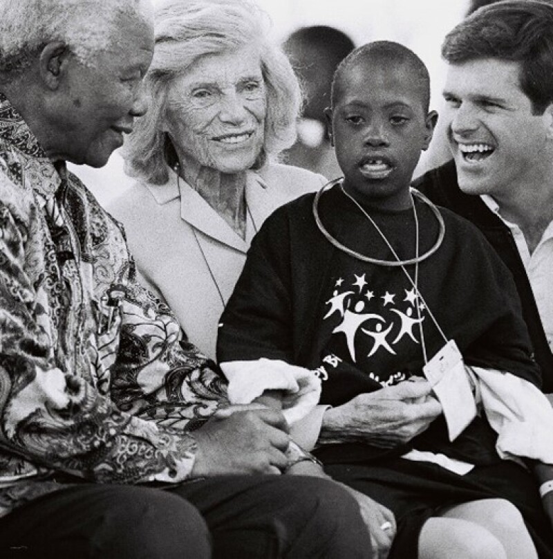 Four people laughing and smiling