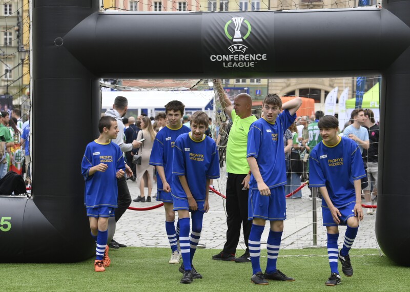 A group of young footballers entering a pitch