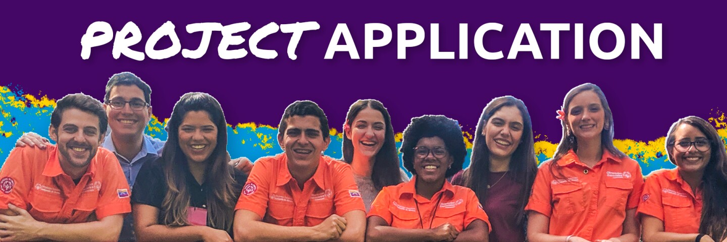 A group of young people post for a photo while leaning against a railing