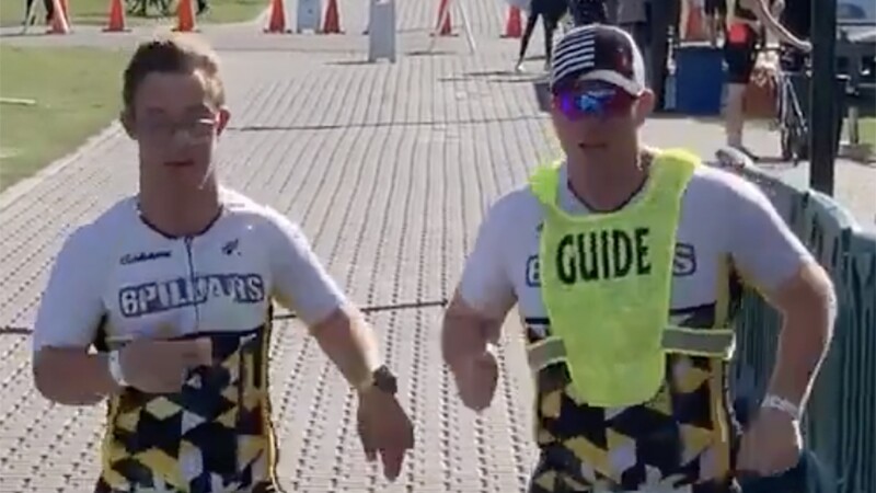 Chris Nikic and Daniel Grieb competing together, running outside.