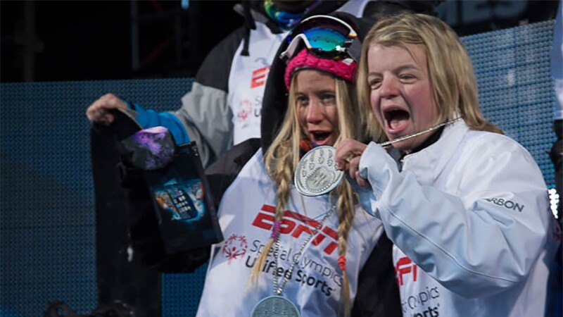 Special Olympics athlete Daina Hannah at X-Games with Hanna Teter showing off medals.