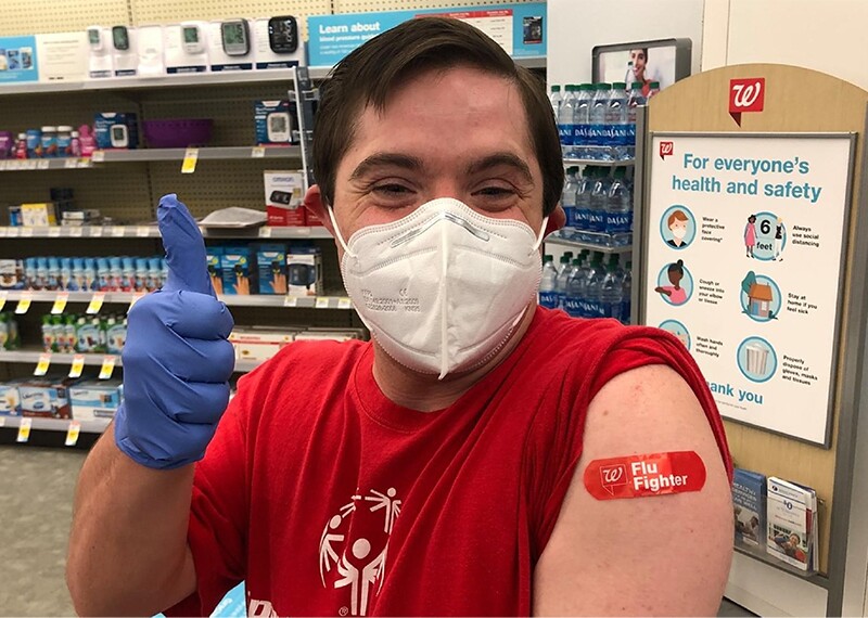 Athlete giving a thumbs up after receiving a flu shot. 