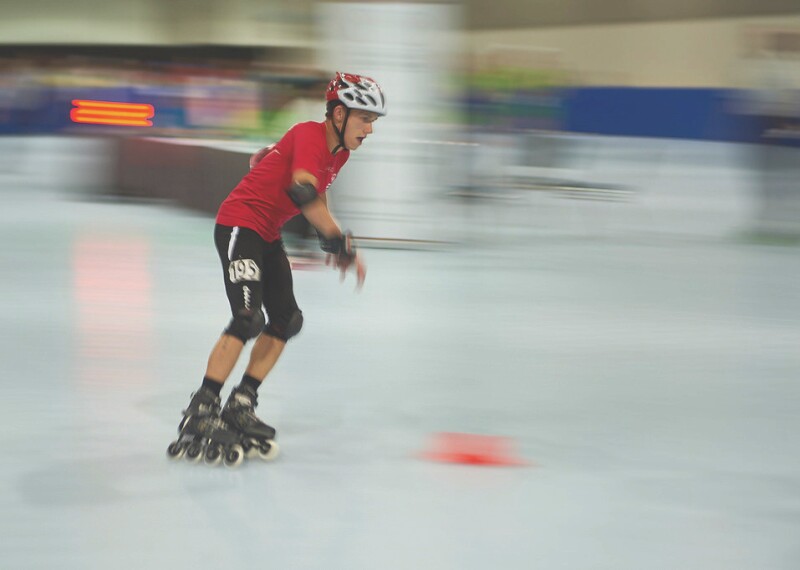 Male athlete rollerblading on the court.
