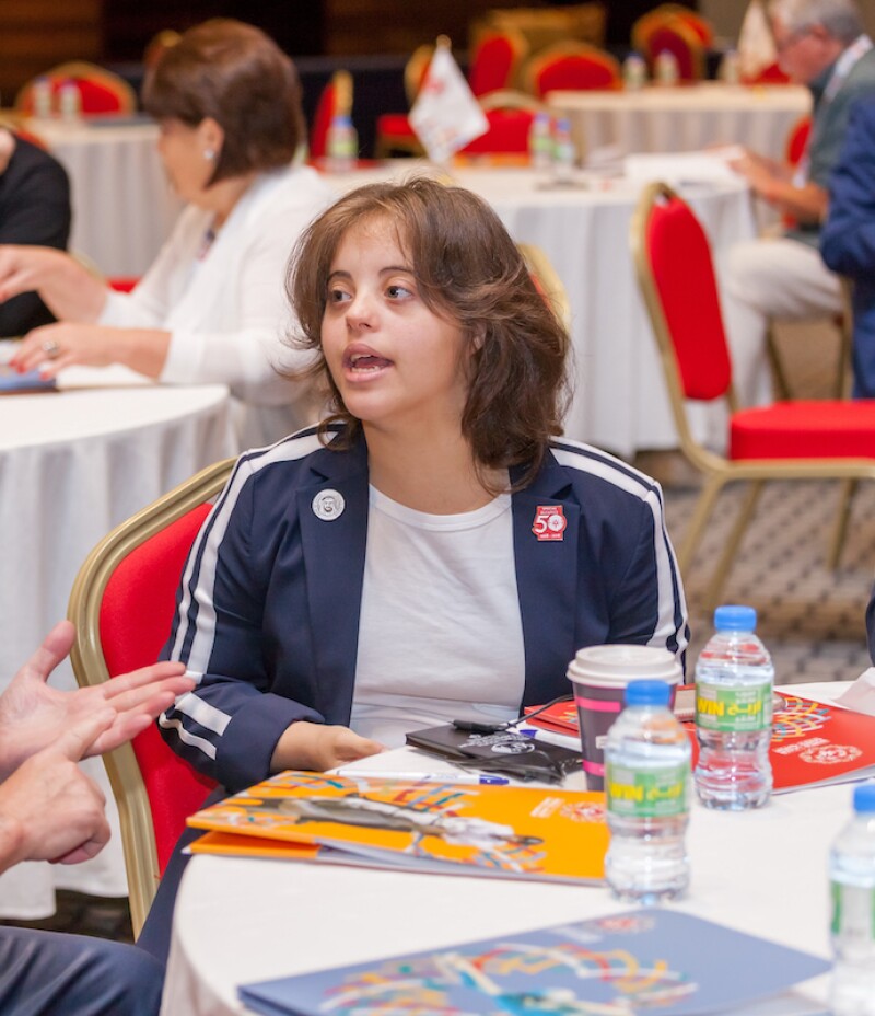 Chaica Al Qassim at a reception table at an Abu Dhabi World Games event