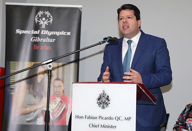 Honorable Fabian Picardo standing behind a podium and speaking