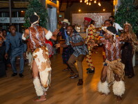 Participants and guests take part in a cultural dance performance during a community celebration event.