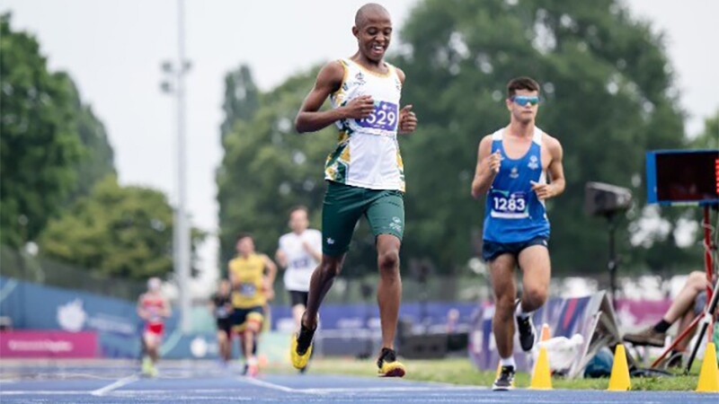 Athletes running on an outdoor track. 