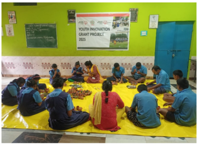 Young people sitting on the floor in a circle. 