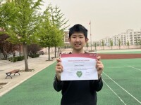 Jianyu proudly displays his leadership certification from Special Olympics 