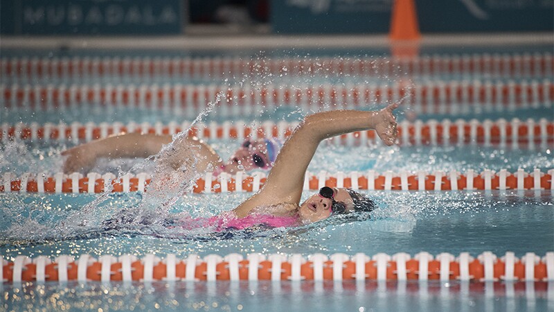 Two athletes swimming in a race.