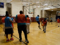 Participants compete in a unified basketball game during an indoor sports program.