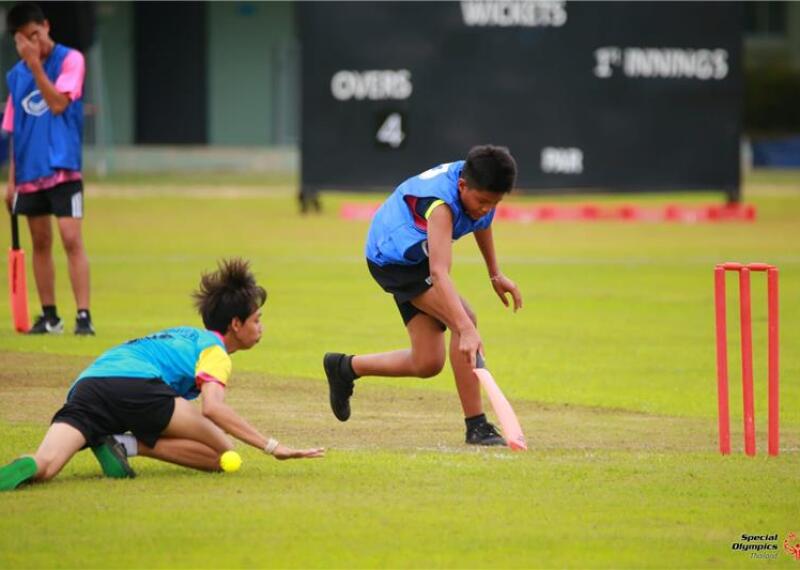 Two athletes playing cricket