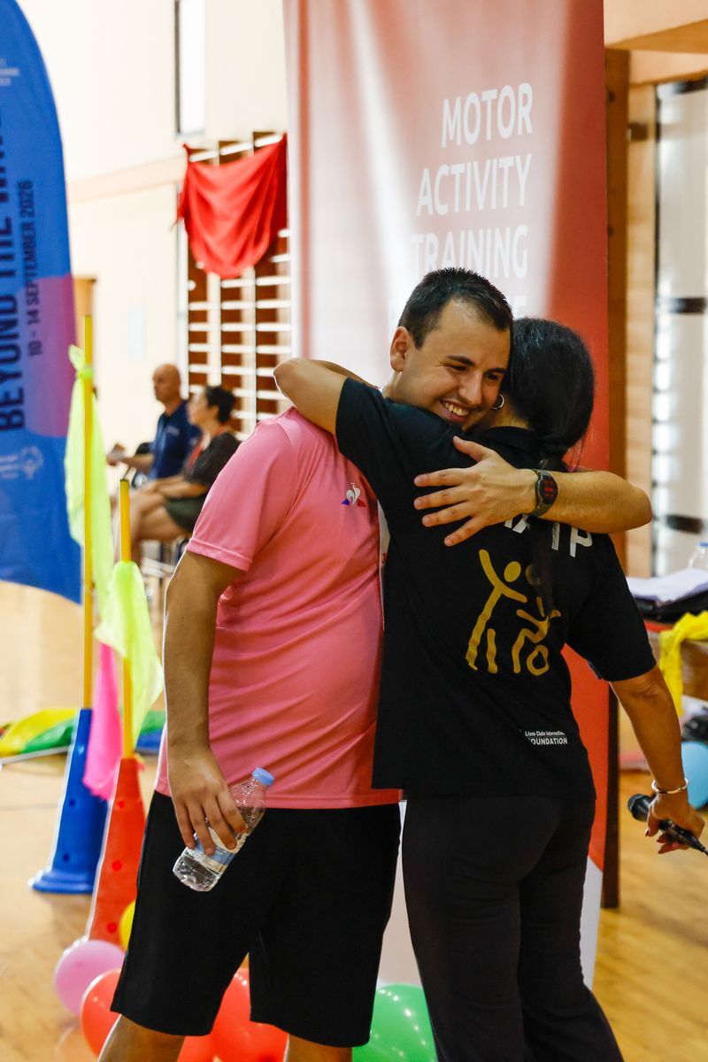 A woman and a young man embracing and celebrating 